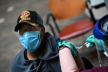 Marine veteran Raymond Dutrieuille, 59, received a dose of COVID-19 vaccine recently at the Minneapolis VA. 