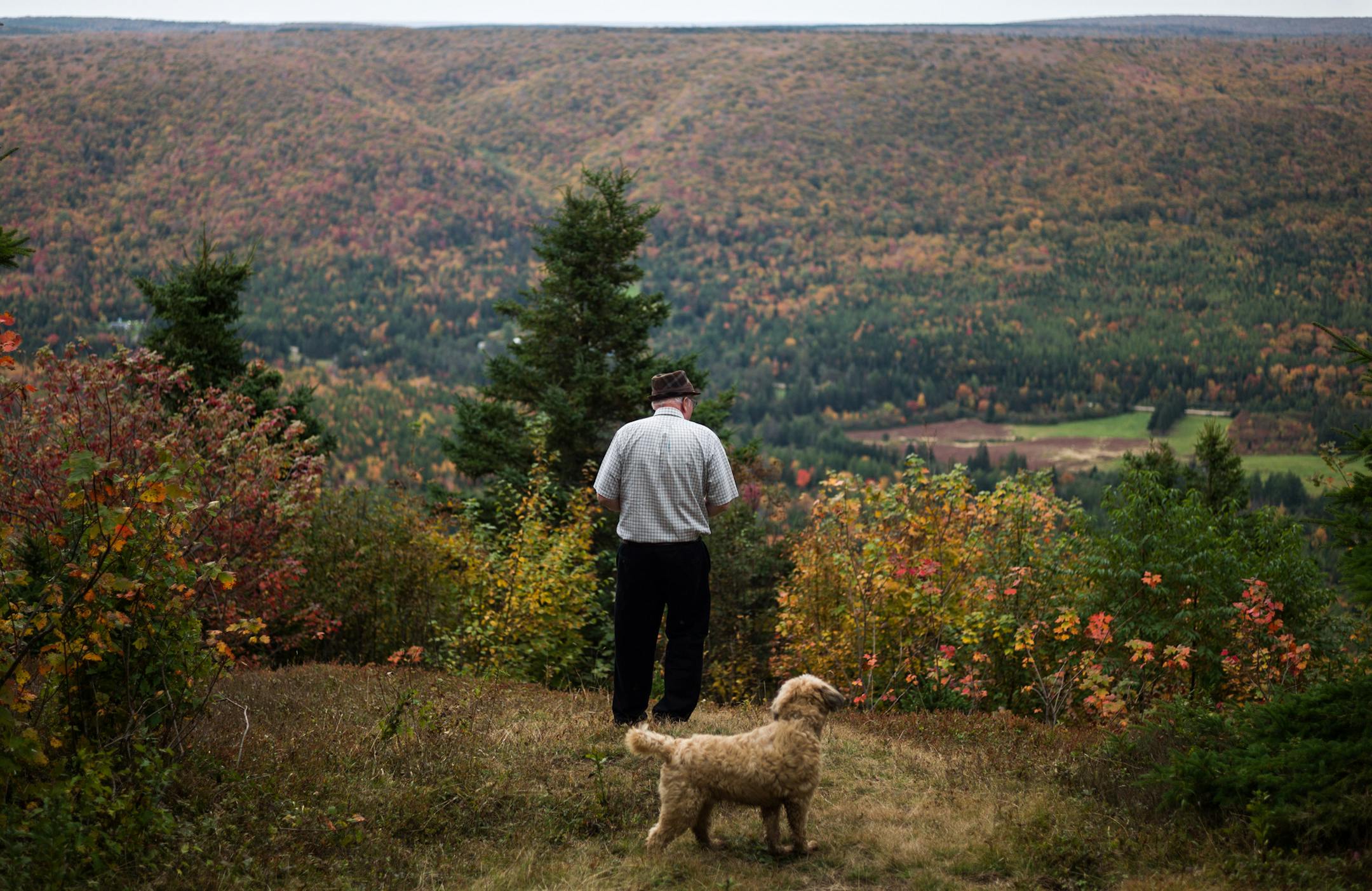Jim Austin stands on a lookout near the edge of his land in Cape Breton, Nova Scotia, Canada, Oct. 13, 2016. Jim Austin and his family are giving away parcels of land to people who will come and work at their market for five years. (Ian Willms/The New York Times)