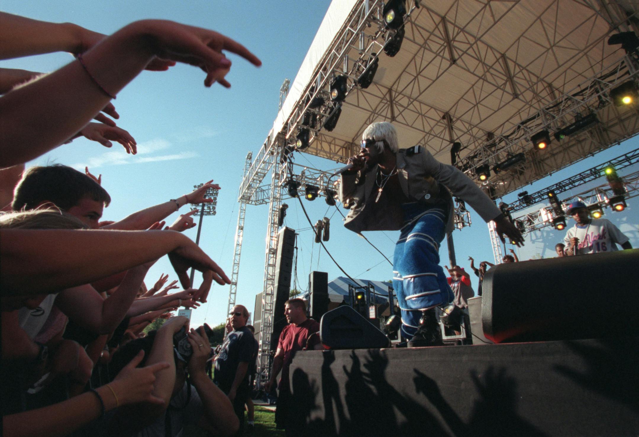St. Paul, MN Thursday 7/26/2001 Area: One festival, an outdoor concert at St. Pauls' Midway stadium featured the duo OutKast, with Andre " Dre 3000" Benjamin ( foreground stage) and Big Boi ( baseball jersey) background.