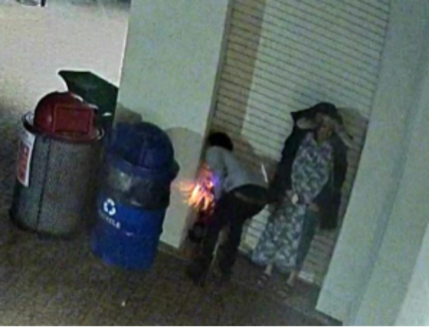 Prosecutors say Nouh O. Elmi, 23, is seen at left in this surveillance photo dumping hot coals outside the Bde Maka Ska/Lake Calhoun restaurant pavilion on May 16.