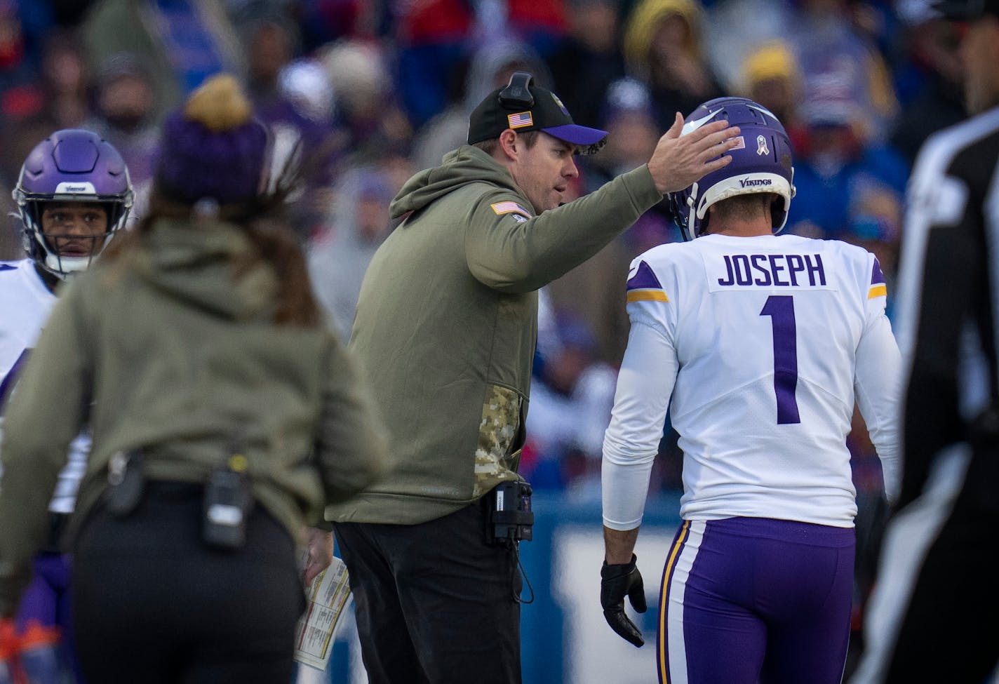 Minnesota Vikings head coach Kevin O'Connell, pats Minnesota Vikings place kicker Greg Joseph (1) on the helmet after he missed a 4th quarter extra point.