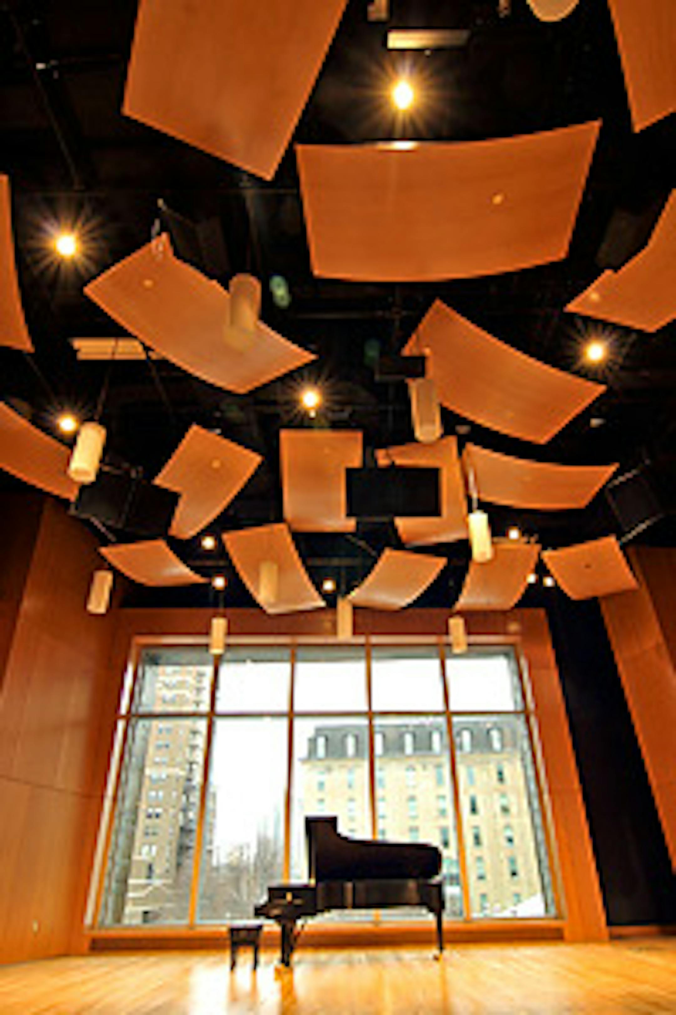 A two-story-tall window is the backdrop for Mac­Phail's new concert hall, paneled in Douglas fir and hung with curved, wooden acoustic "clouds" suspended from the ceiling.
