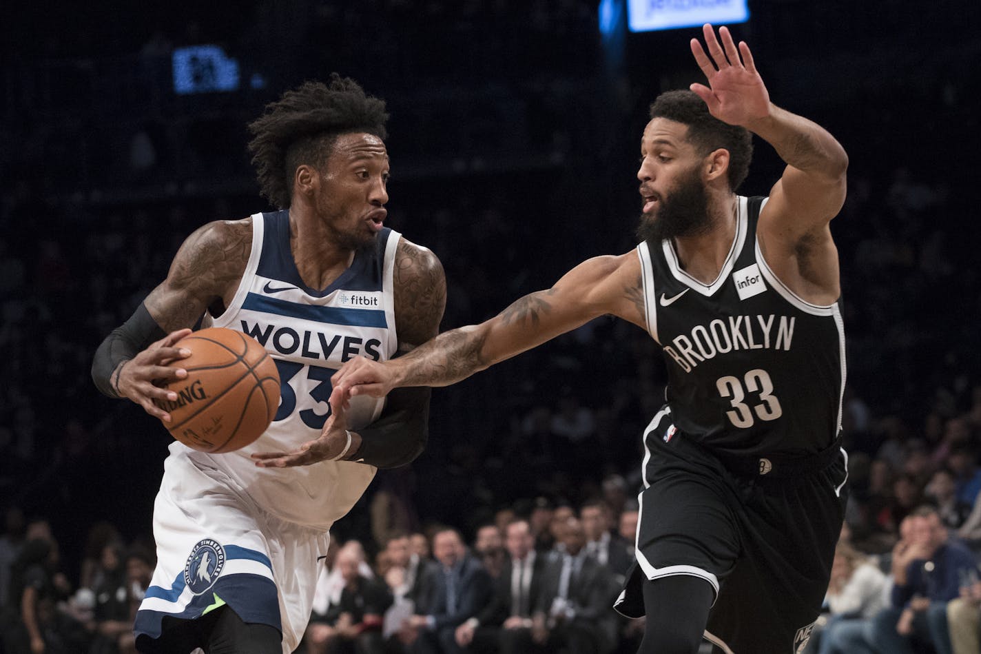 Minnesota Timberwolves forward Robert Covington, left, drives to the basket against Brooklyn Nets guard Allen Crabbe during the first half of an NBA basketball game, Friday, Nov. 23, 2018, in New York. (AP Photo/Mary Altaffer)