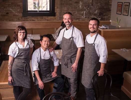 From left: Pastry chef Carrie Riggs, cafe chef Matt Sprague, chef/owner Alex Roberts and restaurant chef Lucas Rosenbrook pose for a portrait in the dining area at Cafe Alma.