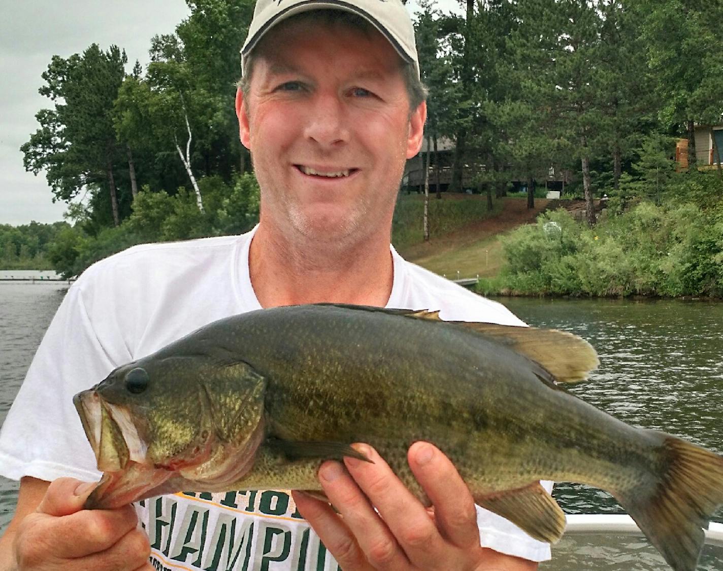 A FIGHTER Tom Gleason of Hanover, Minn., caught this 18-inch largemouth bass while he was fishing for crappies on Little Pine Lake near Crosslake. "This baby attacked my minnow and put up the fight of the summer,'' he said.