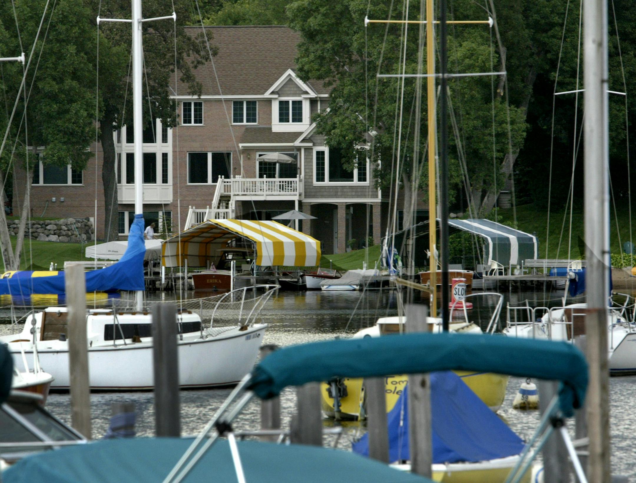 Marlin Levison - Strib 08/12/04-Many residents of Deephaven are upset that Twin Cities builders are allowed to have their Parade of Homes in their city. The residents claim the resulting traffic and crowds are too much to bear. The Deephaven city council will soon vote on allowing the Parade of Homes to continue in their city. NOTE - THE RESIDENTS I TALKED WITH DID NOT KNOW THE LOCATION OF ANY PARADE OF HOMES HOUSES IN DEEPHAVEN.<P> <P>IN THIS PHOTO: Typical of Deephaven homes is this house on a