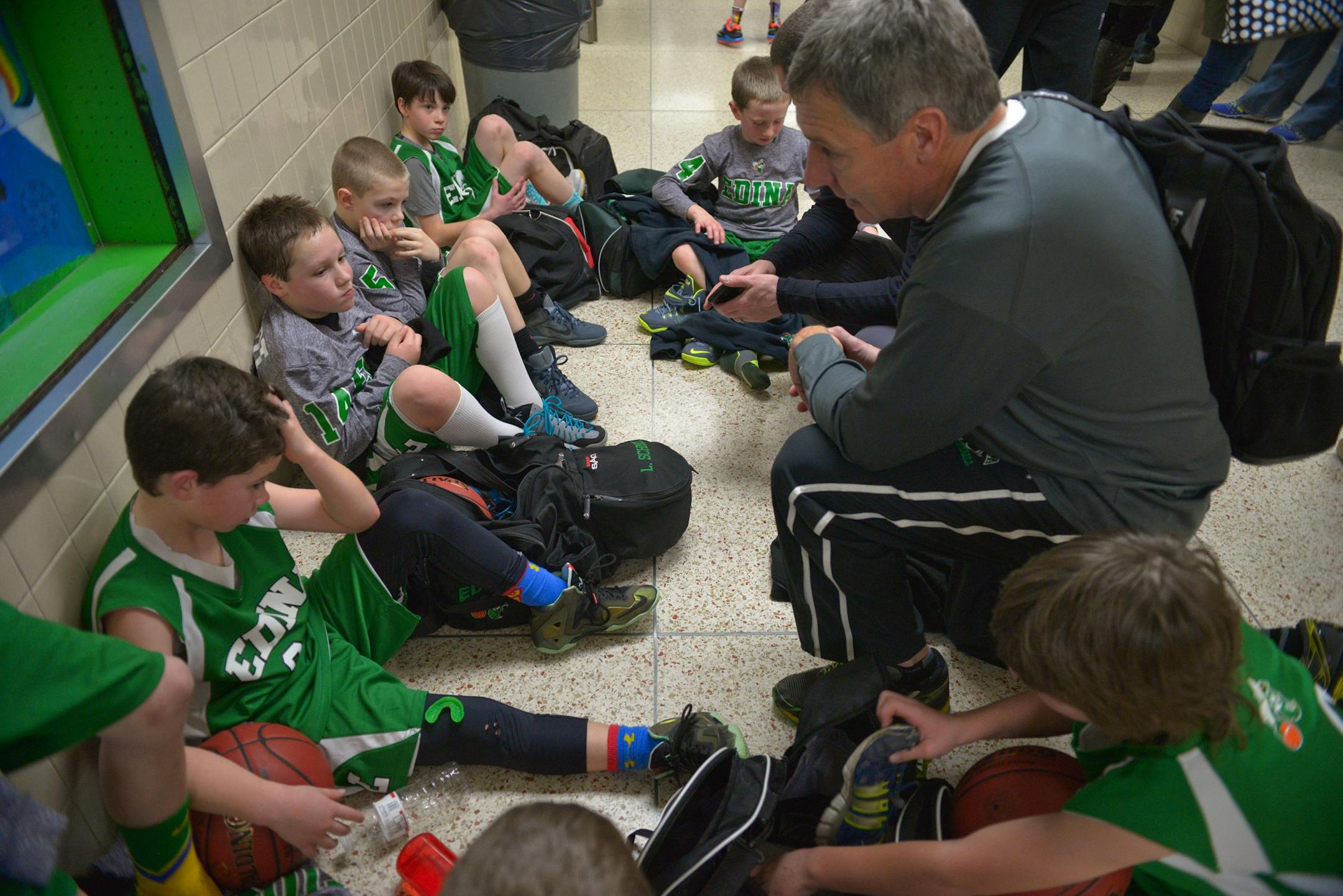 Edina's boys' 4A traveling basketball head coach, Paul Schmidt, talks to his players following a recent tournament loss to Chanhassen.