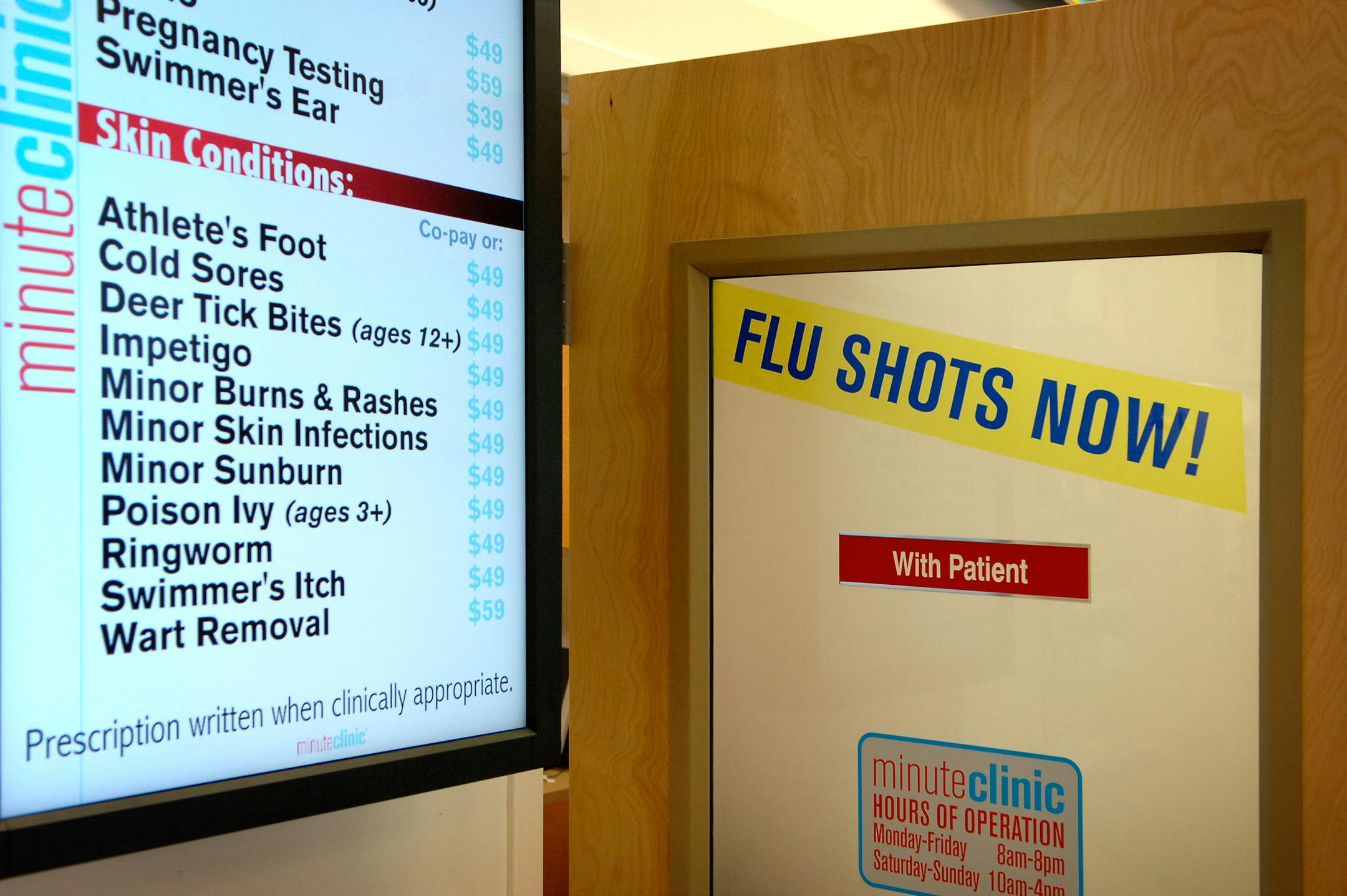 An LCD panel sign lists prices for basic procedures outside the MinuteClinic in the Pymouth CVS store.