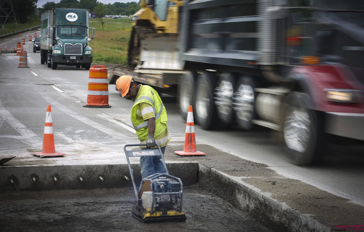 Construction worker Eldio Ferreira worked on a lane of Highway 55 in Inver Grove Heights, Minn. as trucks and cars flew past in the adjoining lane. Starting Aug. 1, the current "Fines Double in Work Zones" standard will be replaced by clearer ones, reading "$300 minimum fines." ] REN&#xc9;E JONES SCHNEIDER &#x2022; reneejones@startribune.com