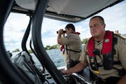Hennepin County Sheriff’s special deputy Amir Gharbi searched for possible boater infractions as deputy Jeremy Gunia steered their boat during a pat