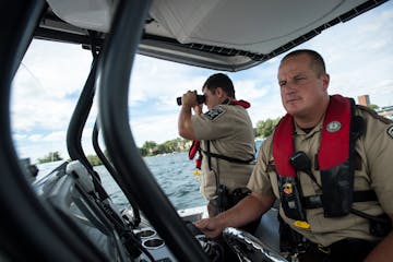 Hennepin County Sheriff’s special deputy Amir Gharbi searched for possible boater infractions as deputy Jeremy Gunia steered their boat during a pat