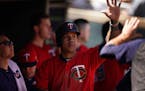 Minnesota Twins shortstop Ehire Adrianza (13) was congratulated after he scored in the sixth inning. ] ANTHONY SOUFFLE &#x2022; anthony.souffle@startr