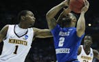 Middle Tennessee's Antwain Johnson (2) is hit in the face as he drives past Minnesota's Dupree McBrayer (1) during the first half of an NCAA college b