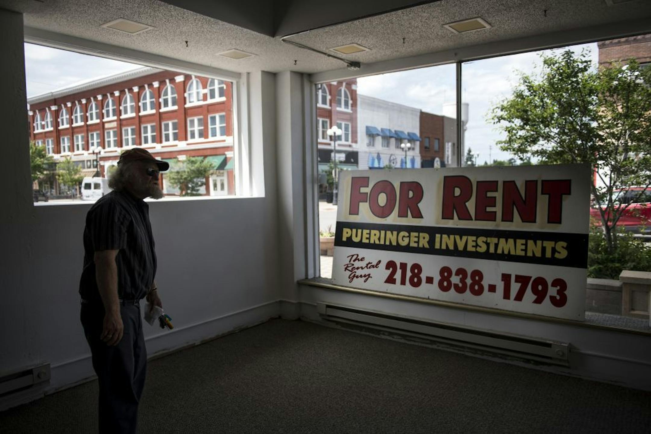 Dave Pueringer, an owner of numerous downtown Brainerd commercial and residential properties, waited in one of his vacant units for contractors to arrive Wednesday afternoon to finish the flooring.