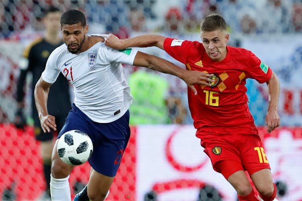 England's Ruben Loftus-Cheek, left, and Belgium's Thorgan Hazard fight for the ball during the Group G match. Both teams advanced.