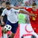 England's Ruben Loftus-Cheek, left, and Belgium's Thorgan Hazard fight for the ball during the Group G match. Both teams advanced.