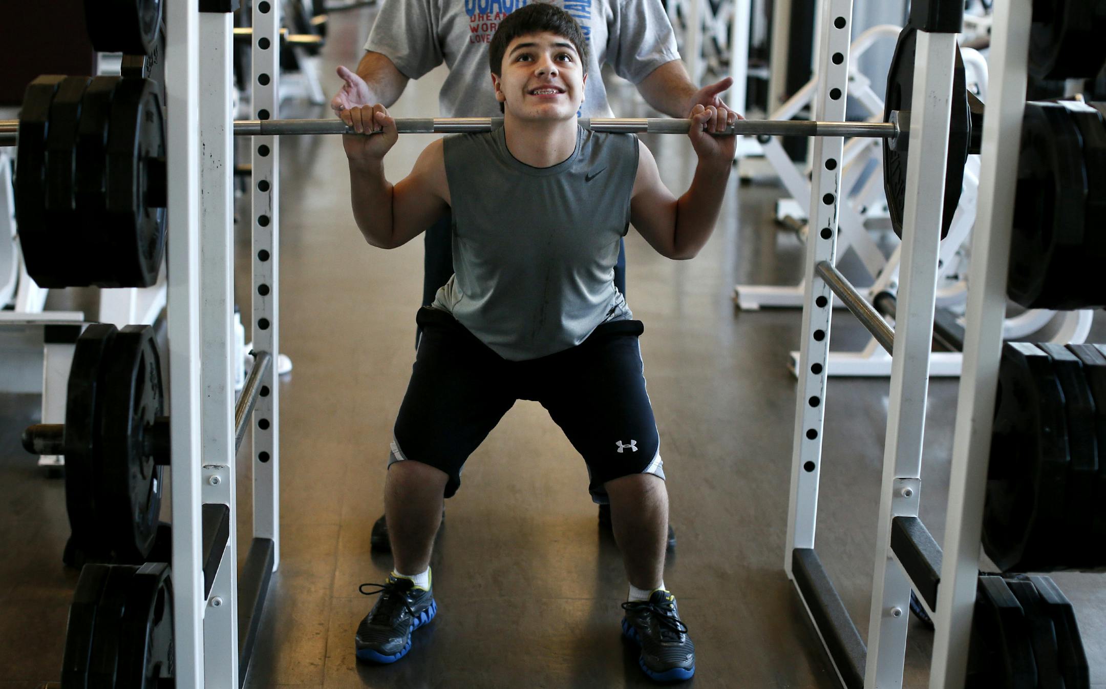 Ethan Martin, 14, lifted weights as his dad, Brett, spotted for him Sunday at Lifetime Fitness in Savage.