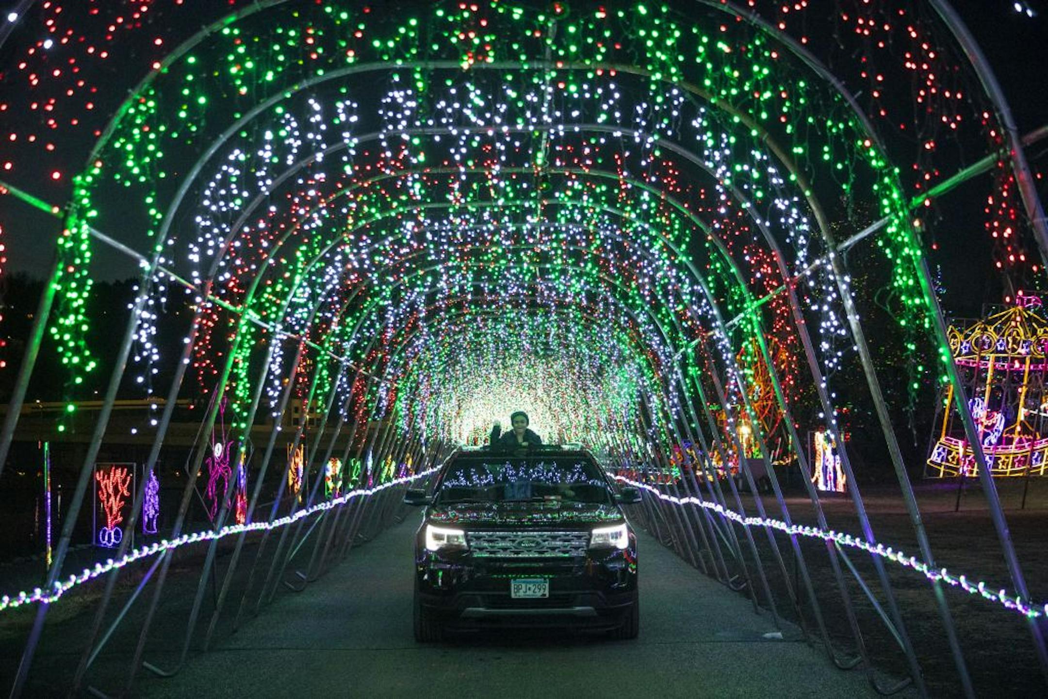 Lilian Reing, 6, from Cook, Minn. stuck her head out of the sunroof as her family drove through the first tunnel of lights.