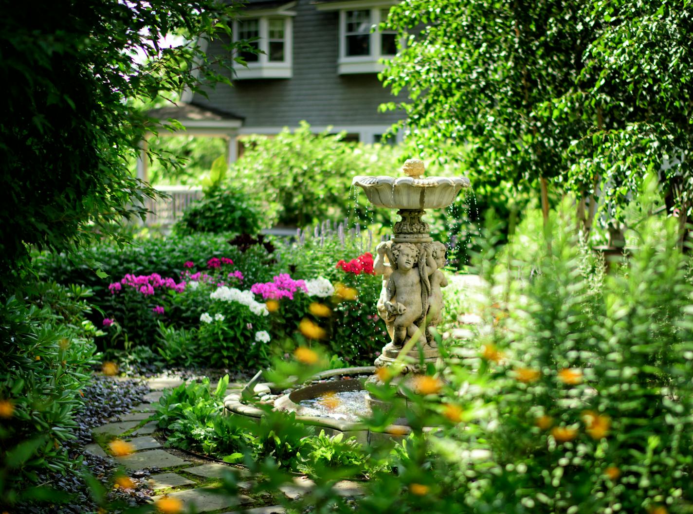 Beautiful Gardens winners Mark Addicks and Tom Hoch who tend a secluded backyard garden at their Lowry Hill home. ] GLEN STUBBE * gstubbe@startribune.com Friday, July 15, 2016 Beautiful Gardens winners Mark Addicks and Tom Hoch who tend a secluded backyard garden at their Lowry Hill home and a public garden on Lake of the Isles.