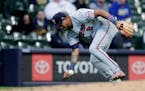 Minnesota Twins' Luis Arraez is unable to field a ground ball during the third inning of an Opening Day baseball game against the Milwaukee Brewers Th