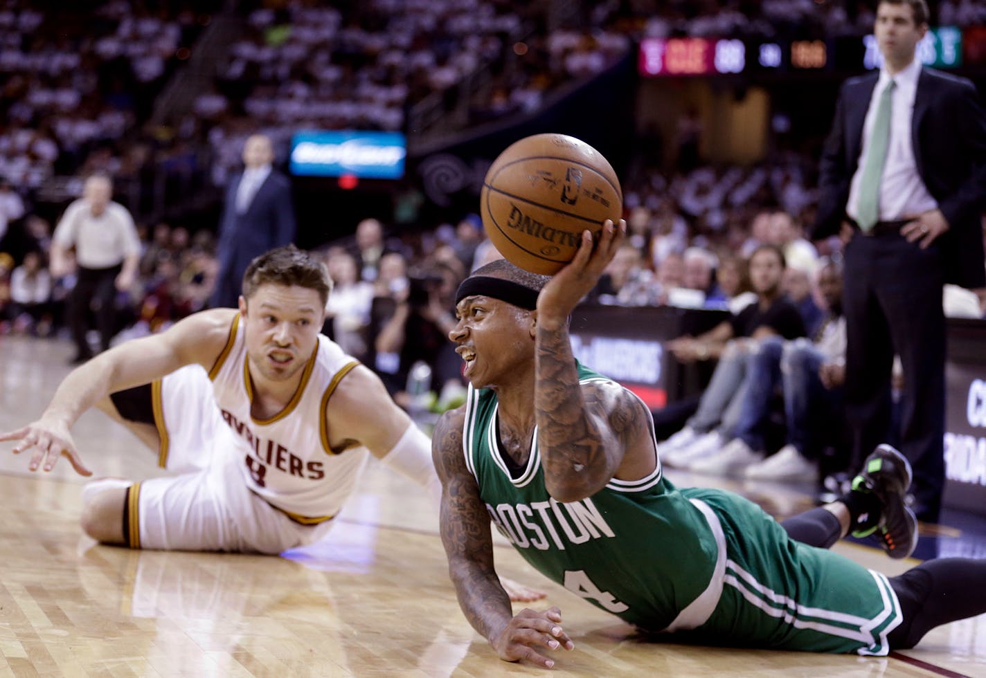 Boston Celtics' Isaiah Thomas (4) passes after tangling with Cleveland Cavaliers' Matthew Dellavedova, from Australia, in the third quarter of a first round NBA playoff basketball game Sunday, April 19, 2015, in Cleveland. Thomas scored 22 points off the bench to lead Boxton in a 113-100 loss to Cleveland. (AP Photo/Tony Dejak)