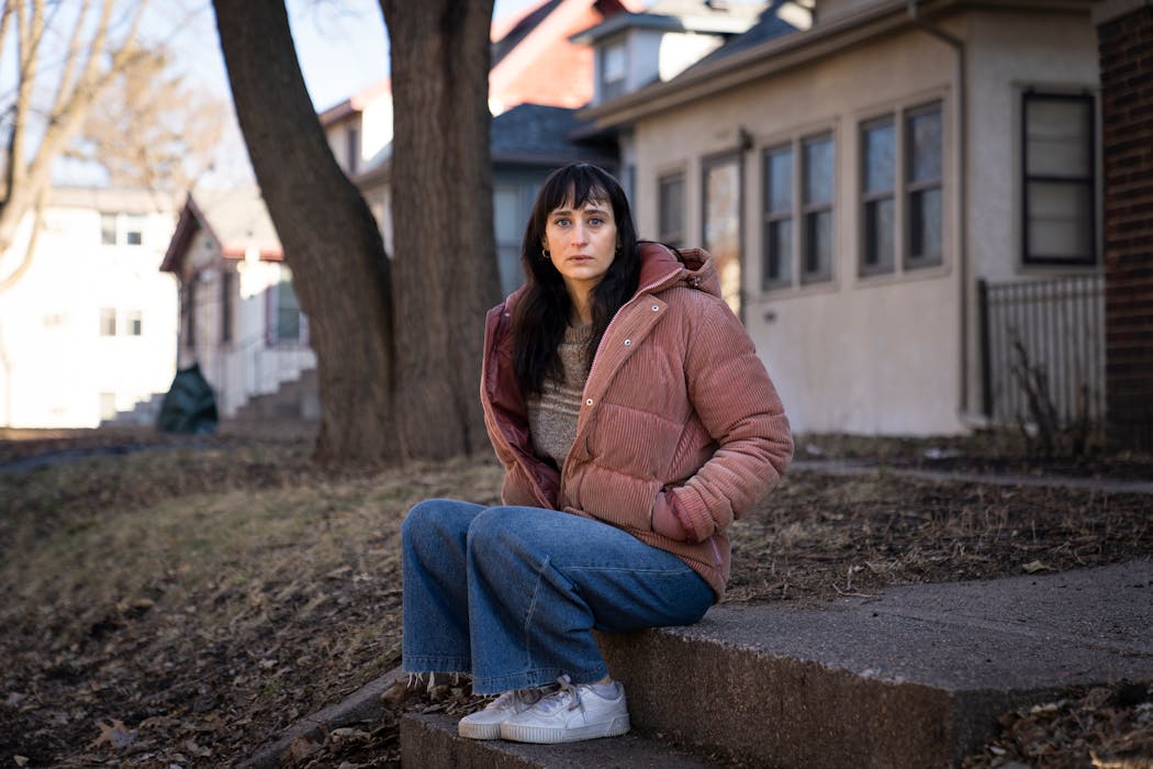 Sarah Beth Ryther posed for a portrait outside her home in Minneapolis on Wednesday. Ryther is a Trader Joe's employee and union leader who says wage growth isn't enough to let retail workers afford the basics.