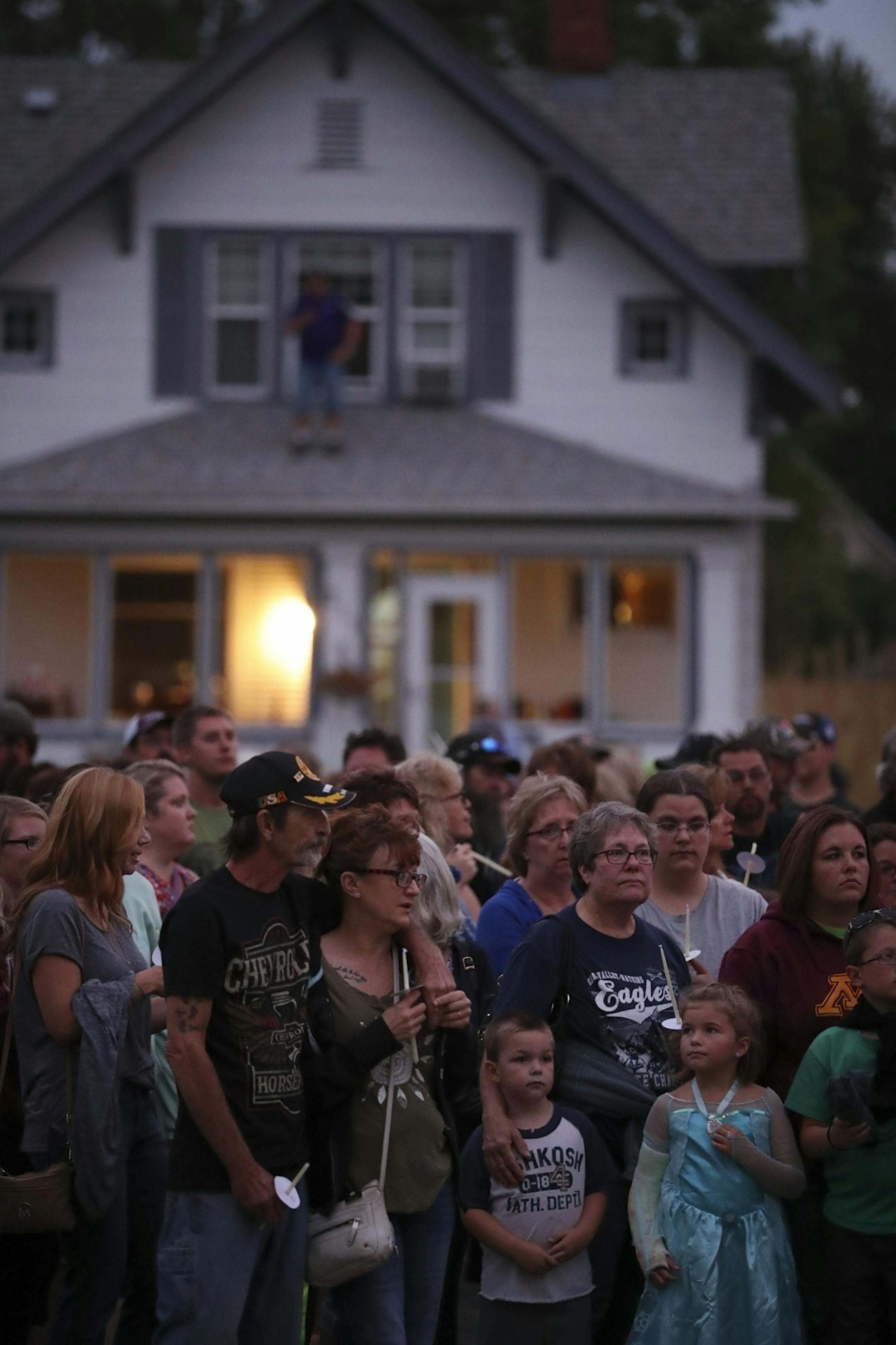 Mourners gathered for the prayer vigil for Alayna Ertl Tuesday night in the parking lot of St. Anthony Church in Watkins.