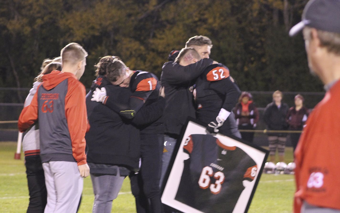 Seniors Bryce Nitsche #1 and Casey Williston #52 present Carter&#xed;s jersey to Randy and Chasity Peterson. ] Photos provided by Ross Pfund, The Norman County Index