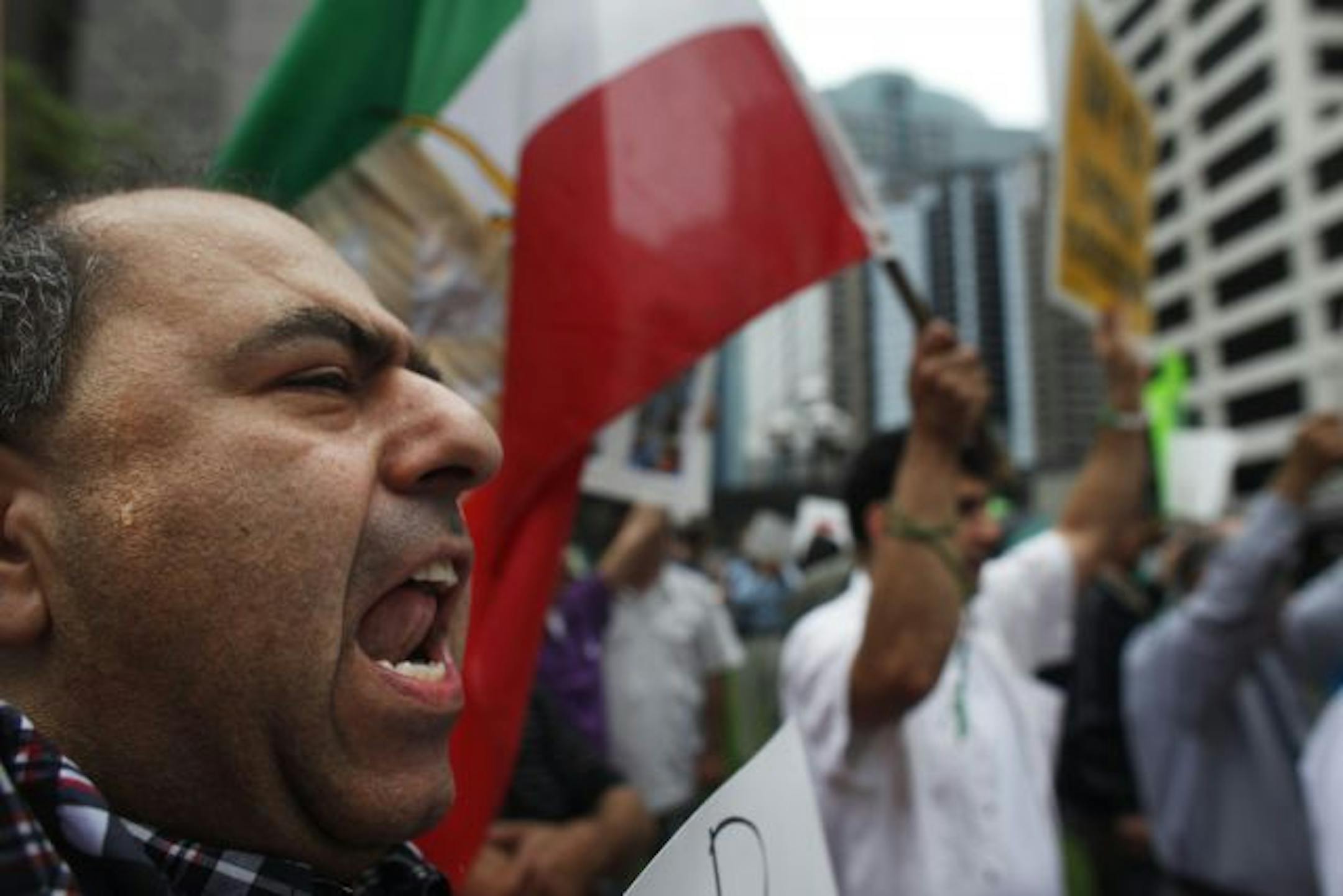 At a "Rally for Democracy in Iran" to declare solidarity with the Iranian people, Mohammad Rointan, an engineer carried a sign "stop killing people." "We need president Obama to condemn Italian brutality," says Rointan.