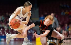 Goodhue guard Lola Christianson grabs a loose ball despite the effort of Underwood guard Trinity Baker in the first Class 1A semifinal Friday.