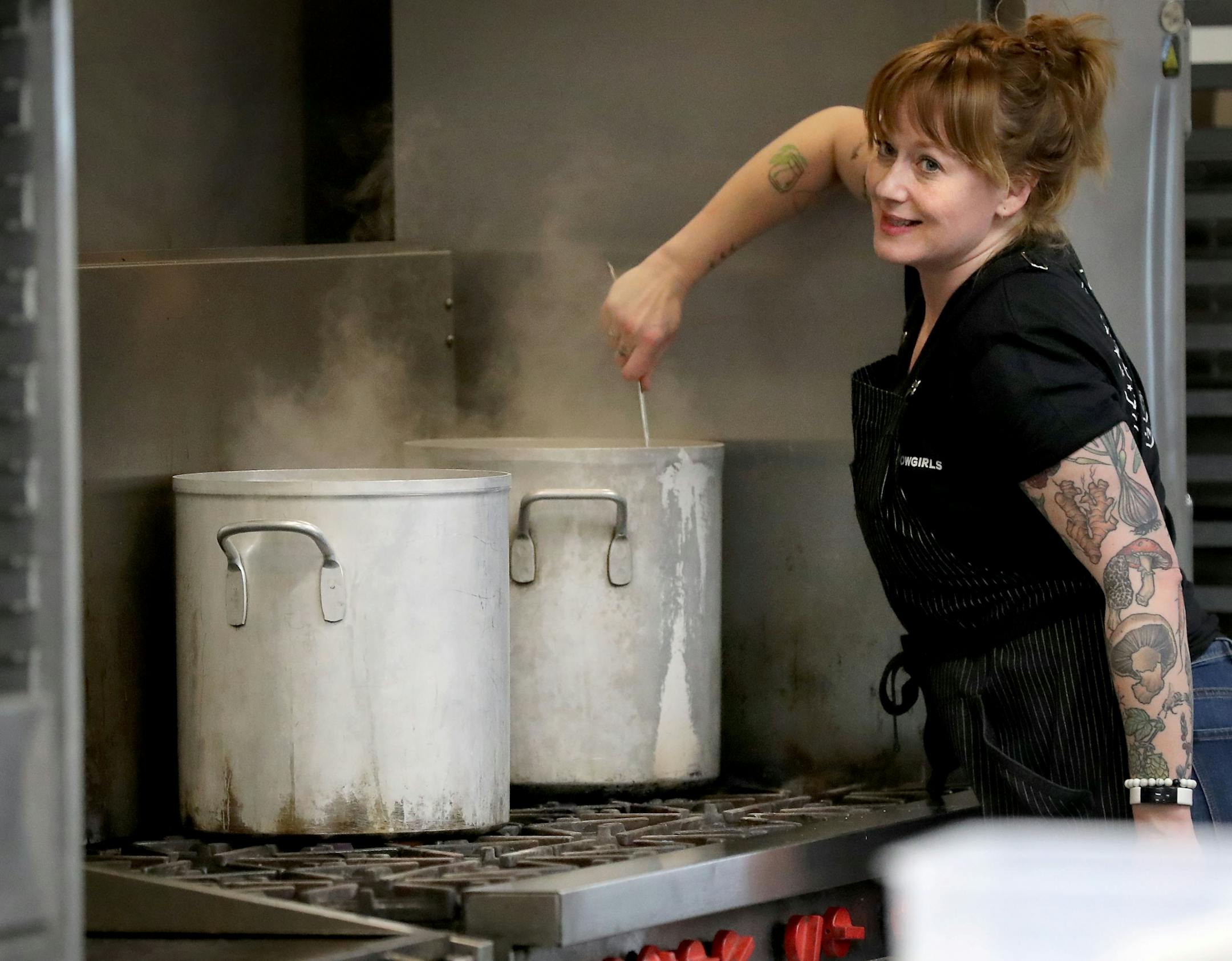 Arianna Baker-Kern, Chowgirls Killer Catering chef de cuisine, stirs a large pot of cooking past that Chowgirls for cooked dishes that will be distributed by Loaves & Fishes to people in need Wednesday, March 18, 2020, in Minneapolis, MN. Much of the food came from Second Harvest Heartland's and much of that was collected from local restaurants that are now closed.