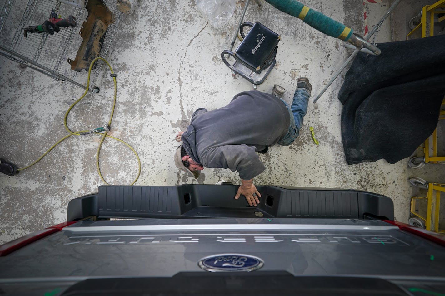 Nate Bennett placed a new number on a Ford 4x4 truck Tuesday, Nov. 14, 2023 St. Paul, Minn. Though inflation is cooling, service prices — including auto repairs — remain high. Latuff Bros. Auto Body, celebrating its 90th anniversary this year, is paying higher wages and more for materials, and having to negotiate with insurance companies in order to remain viable. ] GLEN STUBBE • glen.stubbe@startribune.com