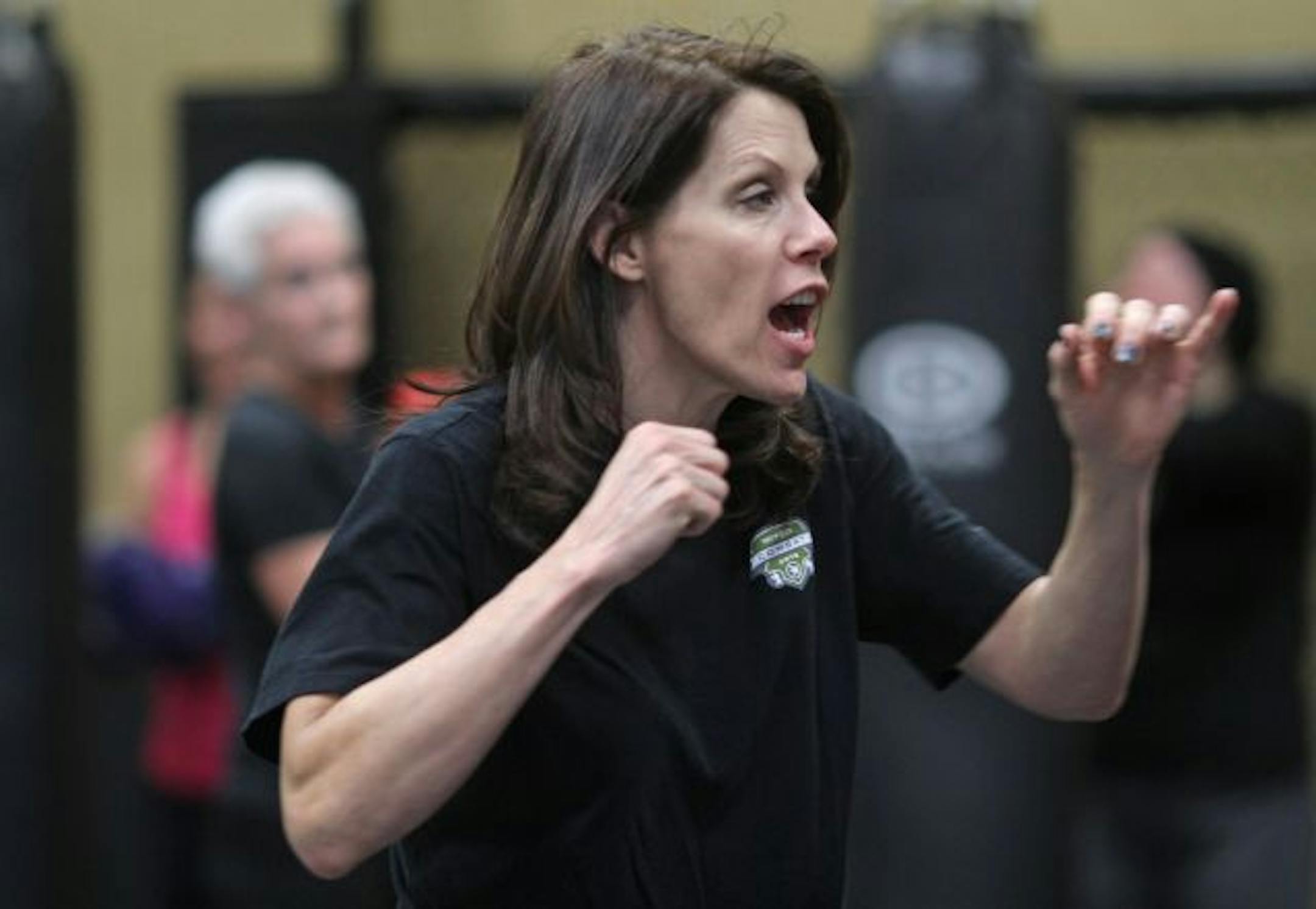 (left to right) Instructor Pat Webber told her students what combination of punches to hit the bag with, during muay thai exercise class at Life-Time Fitness in Chanhassen. Muay thai combines a mixed martial arts style workout with hand to hand combat.