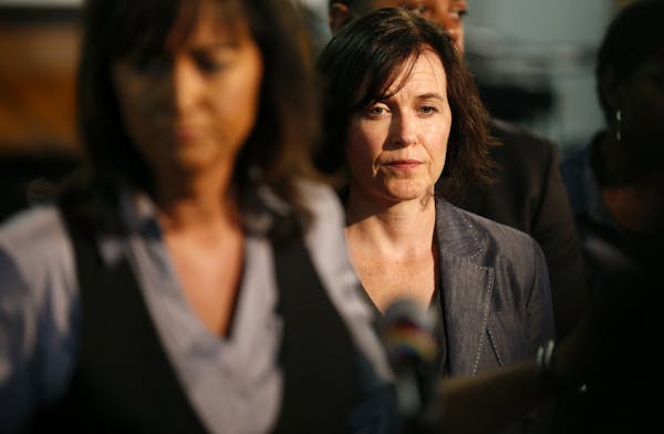 Minneapolis Mayor Betsy Hodges listened as Minneapolis Police Chief Janee Harteau finished addressing the media during a press conference at the Shilo