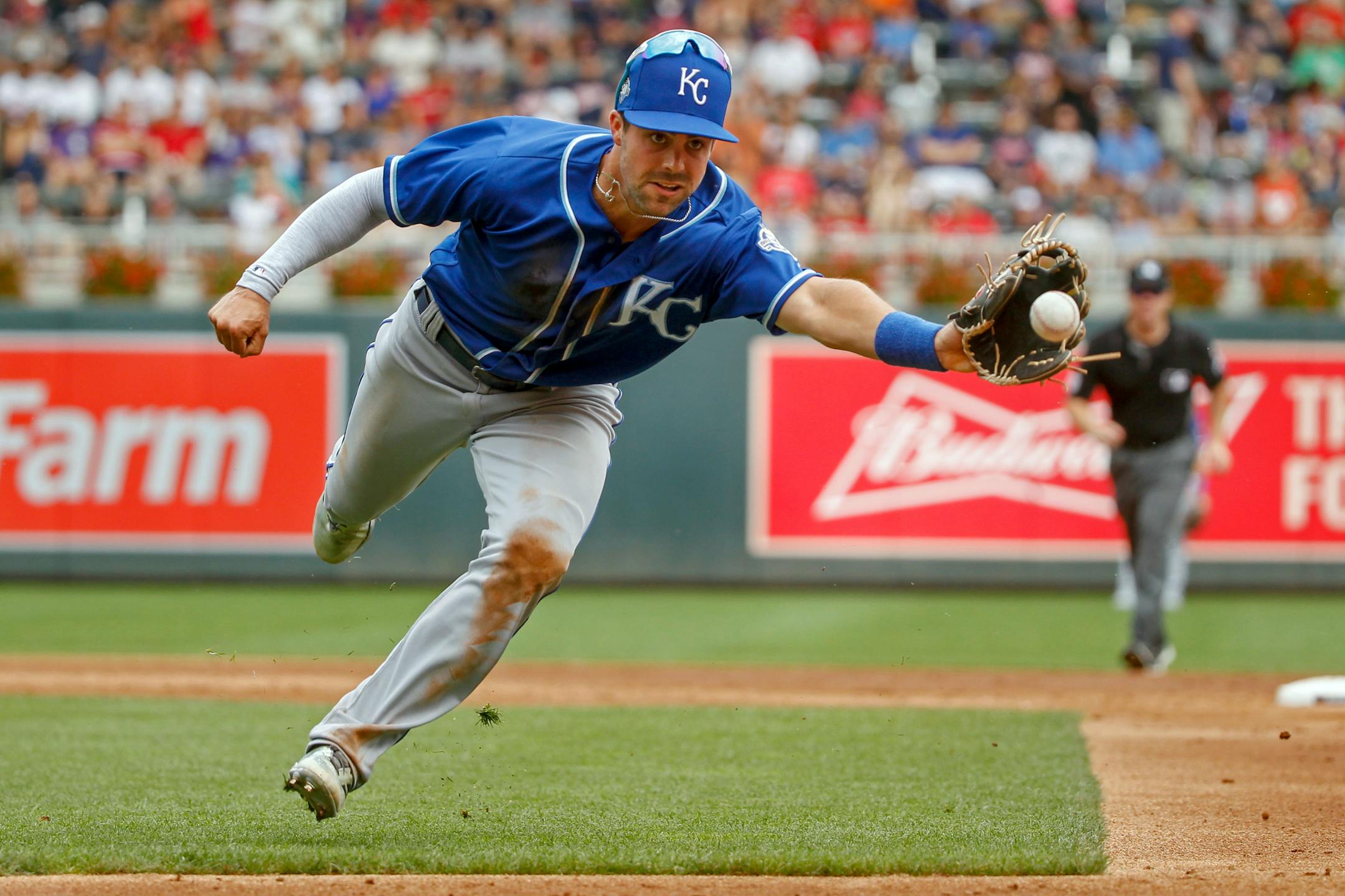 Kansas City Royals second baseman Whit Merrifield flips the ball with his glove to put out Minnesota Twins left fielder Eddie Rosario on a bunt attempt in the third inning of a baseball game Sunday, Aug. 5, 2018, in Minneapolis. The Twins won 6-5. (AP Photo/Bruce Kluckhohn)