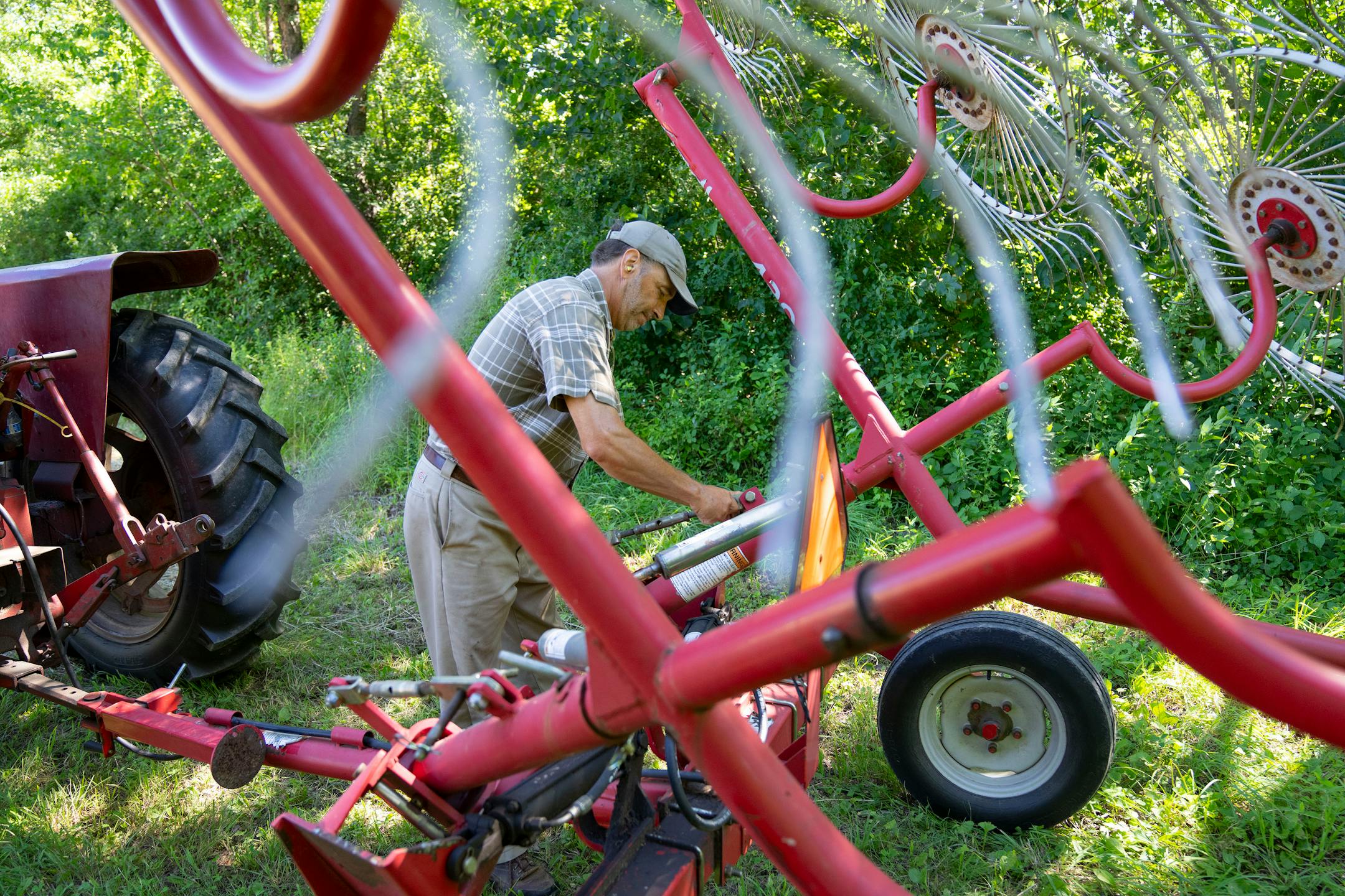 Max Gustafson sets up his tractor to begin raking hay.