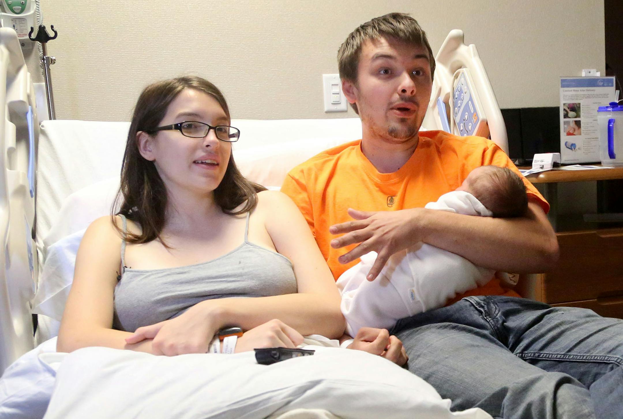 Former Boy Scout Jacob Schindler, 23, right, took the scout motto to heart. Included in the 200 some odd books he reads yearly, Schindler read books on how a baby is born. This July 4th, that preparation paid off for Schindler, who delivered his baby daughter Griffon Elizabeth in the back seat of the family car when mother, Abby Vanyo, 22, left, went into labor en route to the hospital, on I-94 E, near the the Broadway Avenue exit. The family was seen in Vanyo and baby Griffon's room at Abbott N