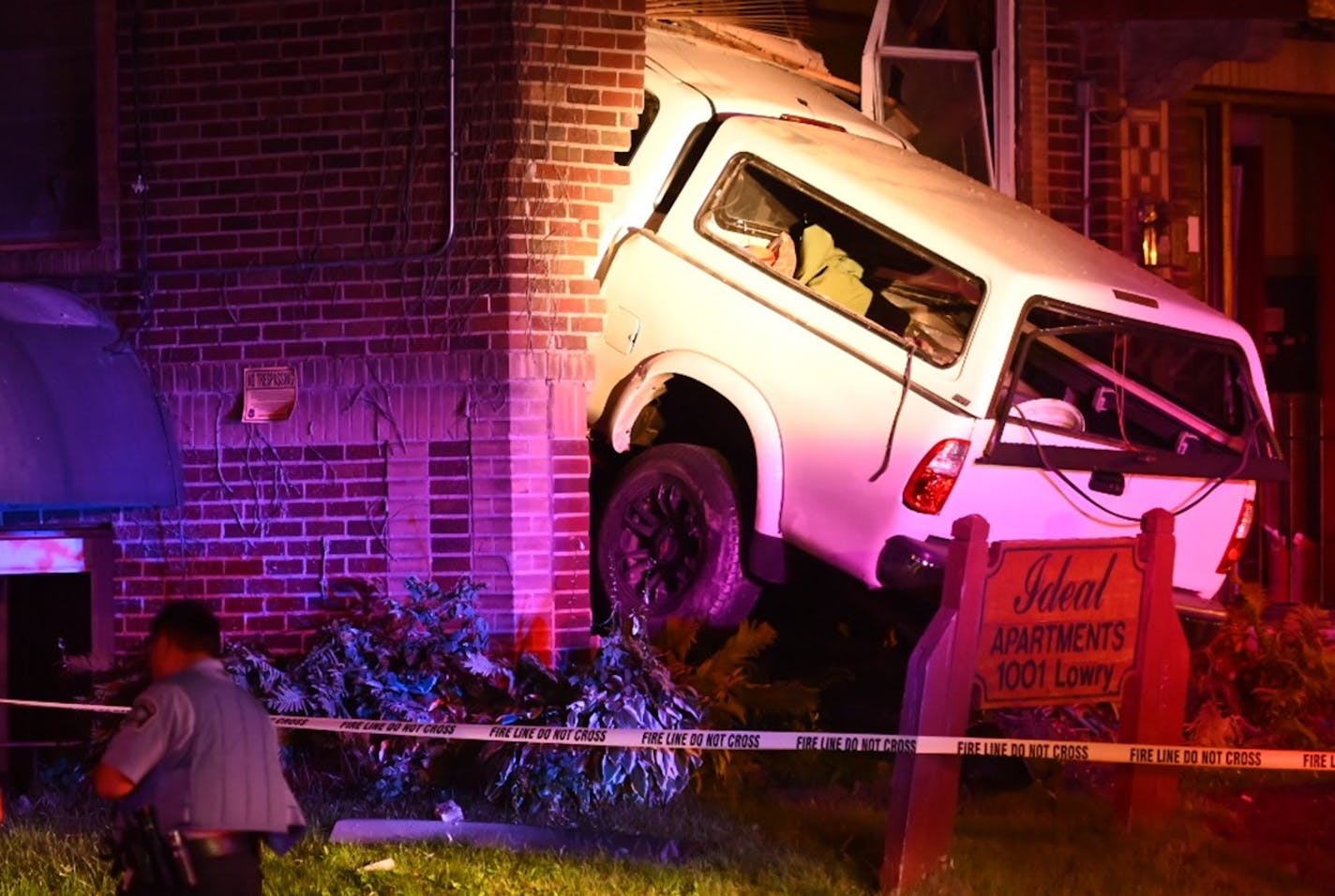 A vehicle slammed into a building Friday night near N. Lowry and Colfax avenues in Minneapolis, leaving 12 people with minor injuries, police said.