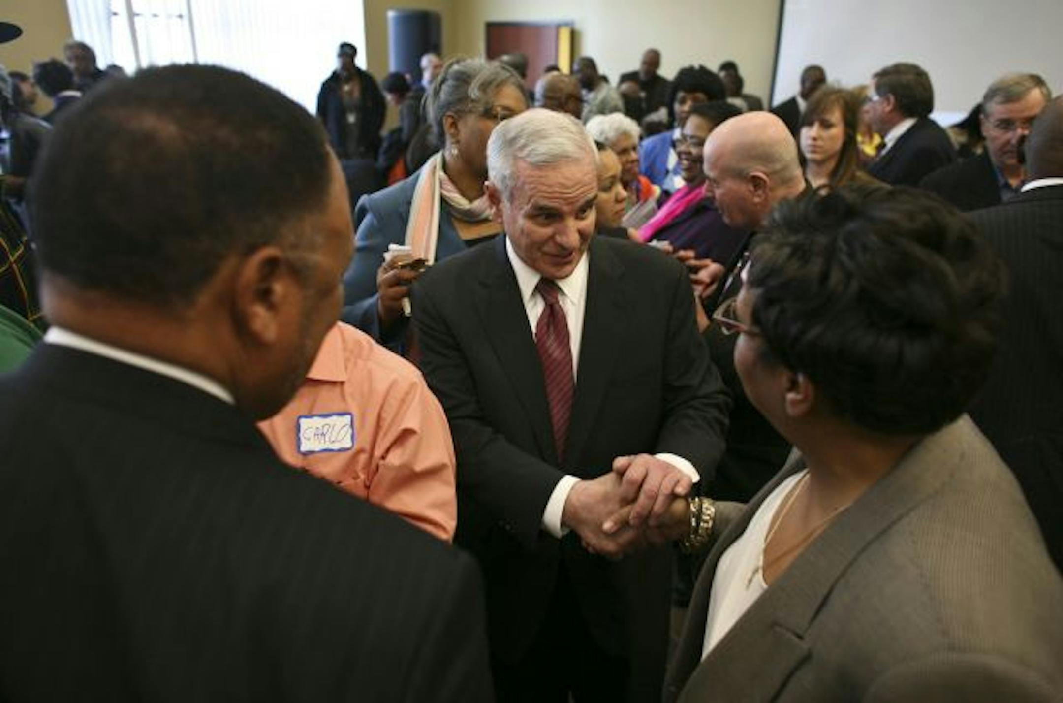 Gov. Mark Dayton shook hands with participants at the "Black Economic Summit" in north Minneapolis. Dayton said he would respond to recommendations in nine days.