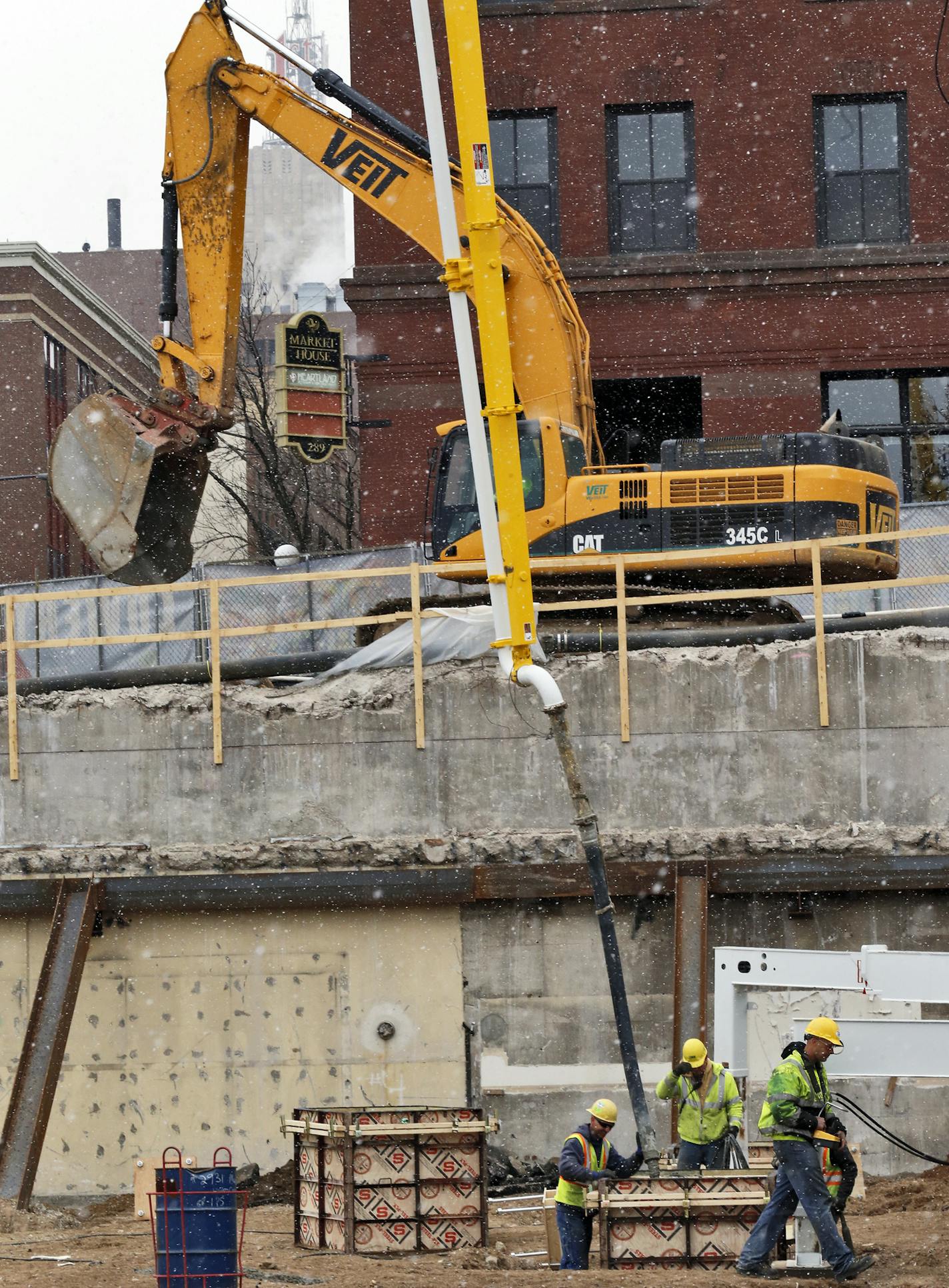 Workers poured cement into the stadium footings.