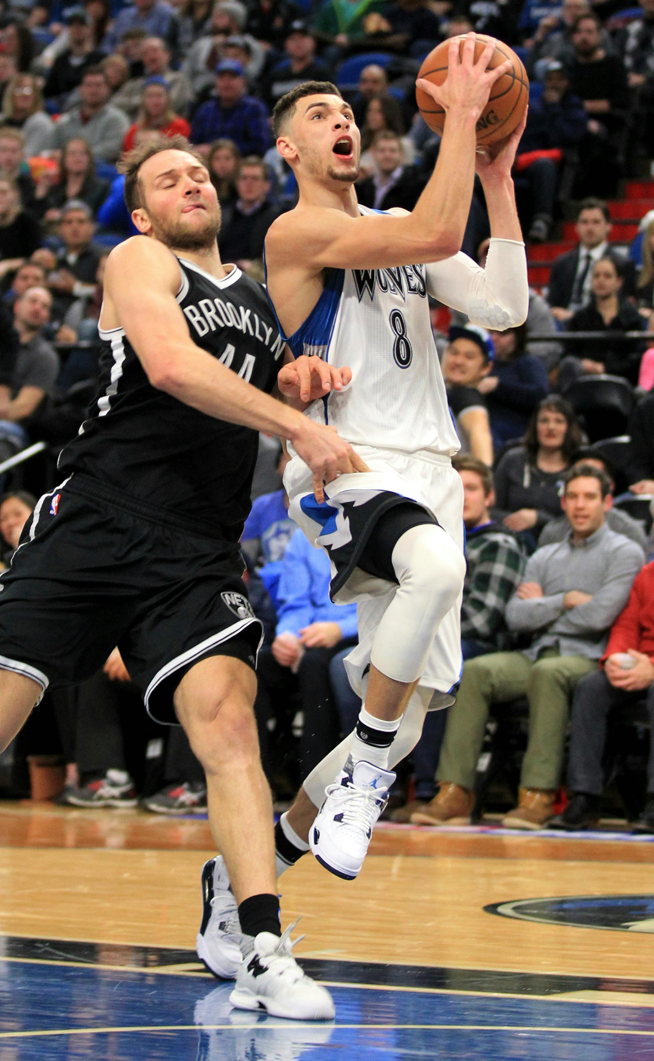 Minnesota Timberwolves guard Zach LaVine (8) is fouled by Brooklyn Nets' Bojan Bogdanovic (44) during the third quarter of an NBA basketball game in Minneapolis, Saturday, Jan. 28, 2017. The Timberwolves defeated the Nets 129-109. (AP Photo/Andy Clayton-King)