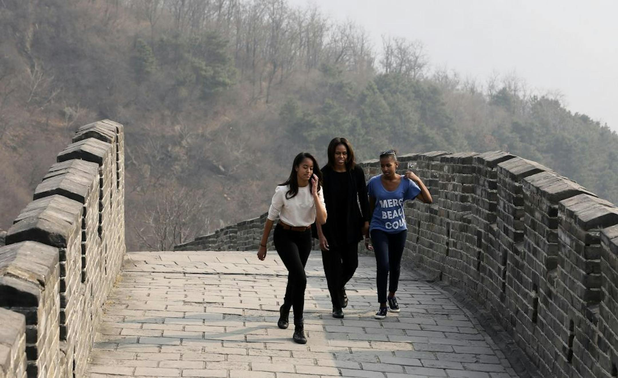First lady Michelle Obama her daughters Malia, left, and Sasha visit the Mutianyu section of the Great Wall in Beijing, China, on March 23, 2014.