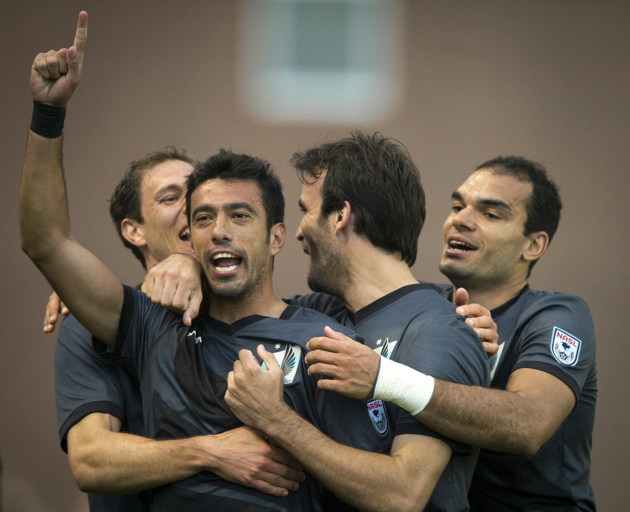 Minnesota FC Players embraced Tiago Calvano, second from left, after Calvano scored a goal against Jacksonville Armada FC in the second half. ] Aaron Lavinsky &#x2022; aaron.lavinsky@startribune.com Minnesota United FC played Jacksonville on Saturday, May 23, 2015 at the National Sports Center in Blaine.