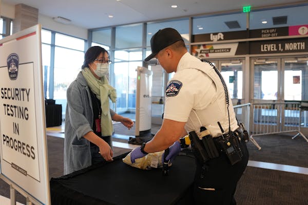 Mall of America security officer Fredericks checks IDs and bags at the Level 1 North Entrance with the new Evolv screeners Tuesday, Oct. 18, 2022 in B