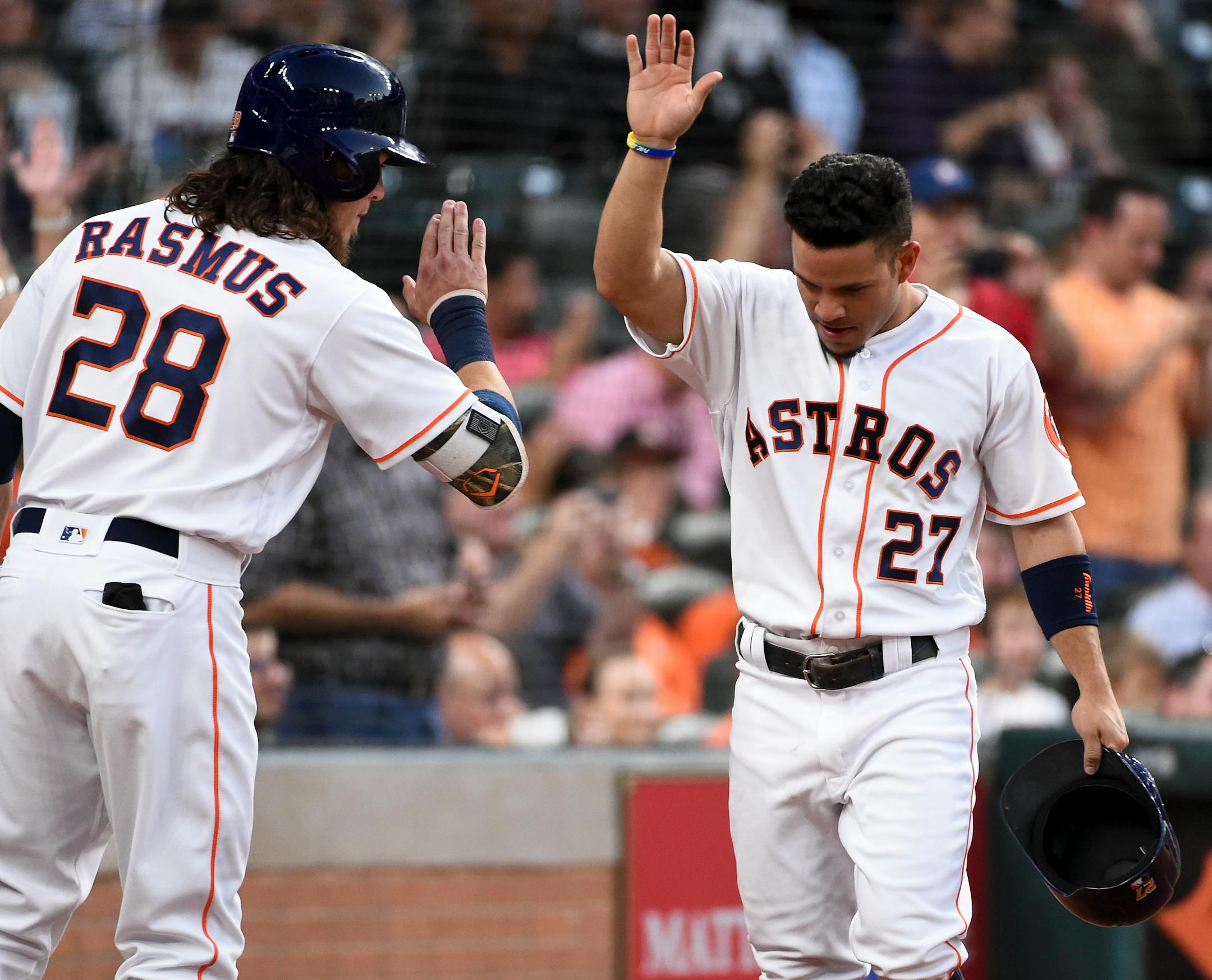 Houston Astros' Jose Altuve (27) celebrates his run scored with Colby Rasmus (28) in the second inning of a baseball game against the Minnesota Twins, Wednesday, May 4, 2016, in Houston. (AP Photo/Eric Christian Smith)