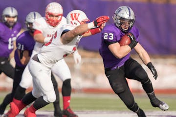 St. Thomas running back Jordan Roberts (23) cuts upfield in the first half as the University of St. Thomas Tommies hosted the Wabash College Little Gi