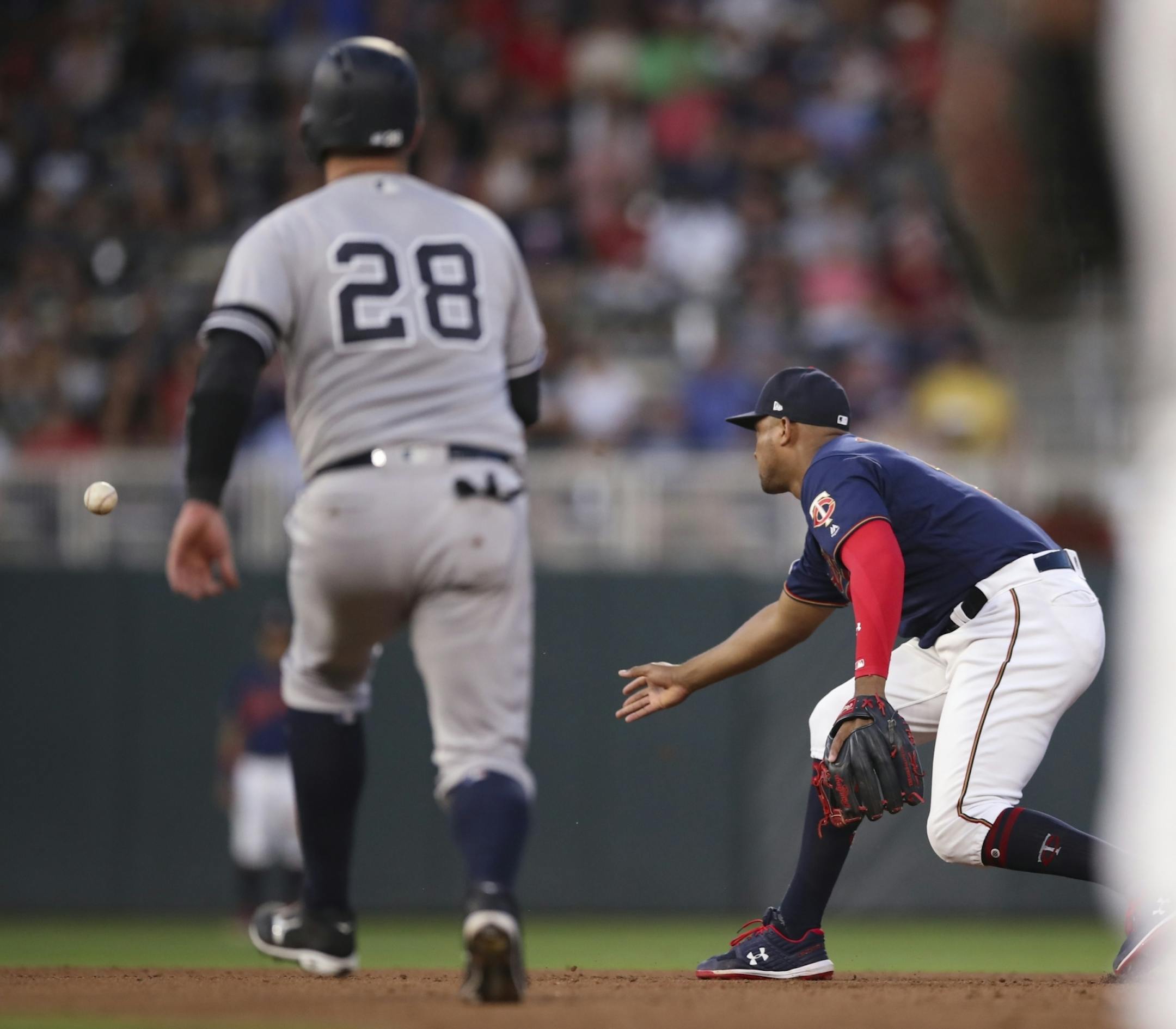 Minnesota Twins designated hitter Nelson Cruz (23) tossed the ball to second base after fielded a fourth inning grounder by Yankees first baseman DJ LeMahieu. LeMahieu reached on a fielder's choice. New York Yankees catcher Austin Romine (28) was out at second.