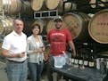 Spell Estate winery owners, Bill and Tiki Spell, are in the barrel room with wine maker, Andrew Berge, a former Minnesotan.