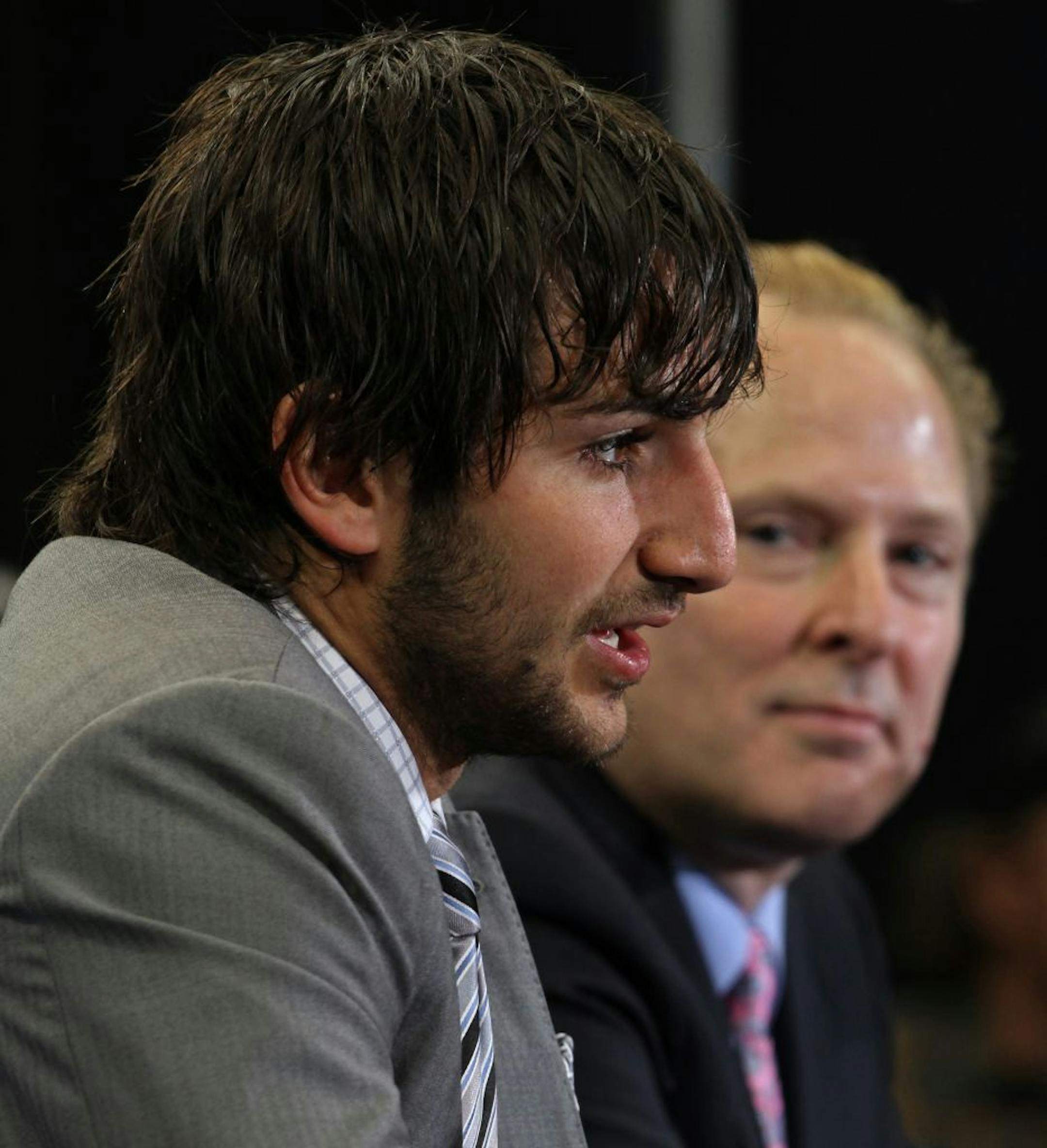 New Timberwolves point guard Ricky Rubio (left) answered media questions as Wolves boss David Kahn watched.