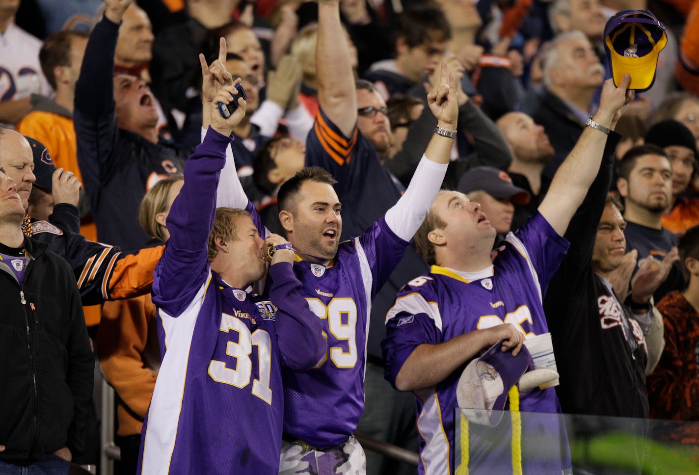 Minnesota Vikings fans cherrs in the first half of an NFL football game against the Chicago Bears in Chicago, Sunday, Oct. 16, 2011. (AP Photo/Nam Y. Huh)